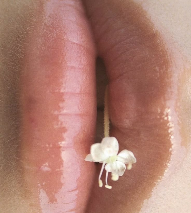 Glossed lips, small flower