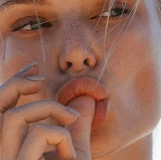 Freckles, finger to lip
